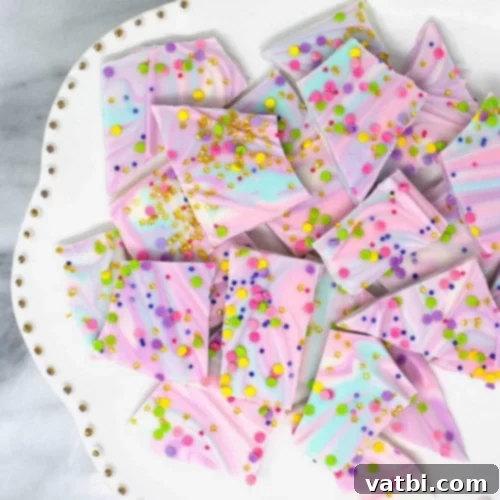 37 Magical Unicorn Desserts 5 Colorful White Chocolate Unicorn Bark with candy pearls, edible gold stars, and sprinkles.
