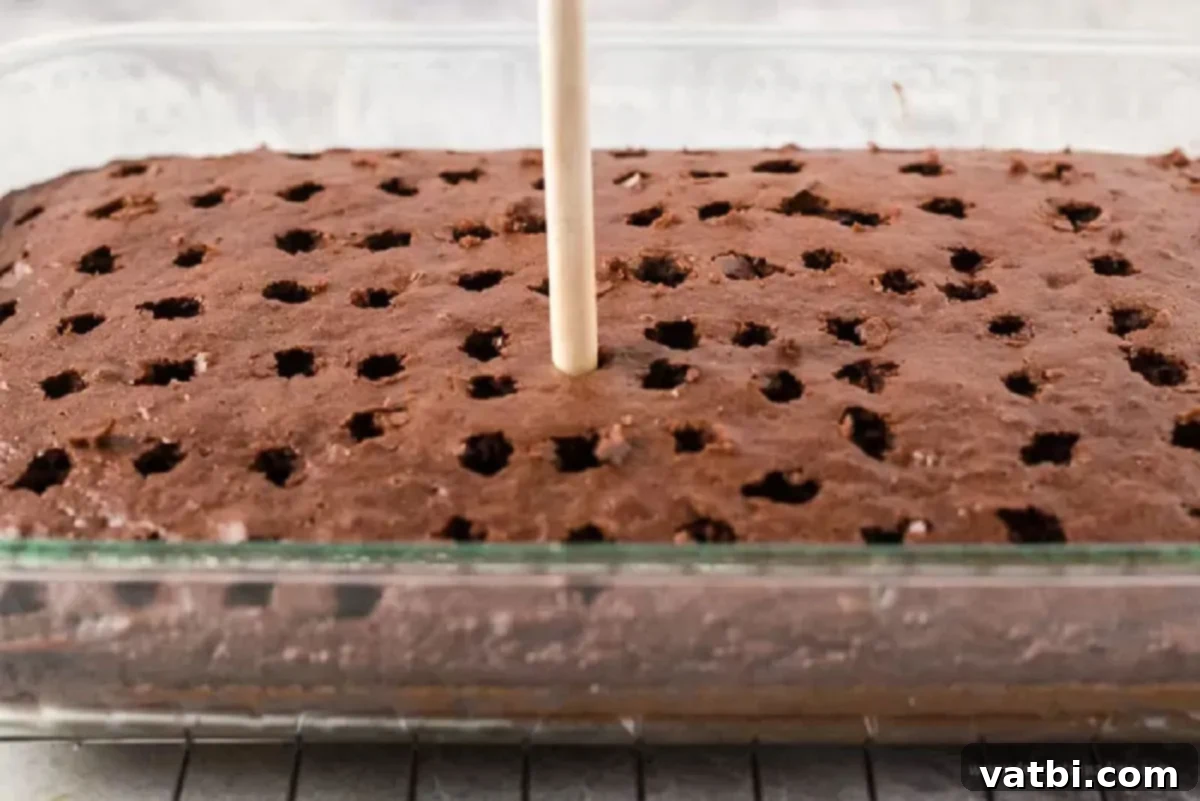 Decadent Dream Cake 2 Cake being poked with holes.