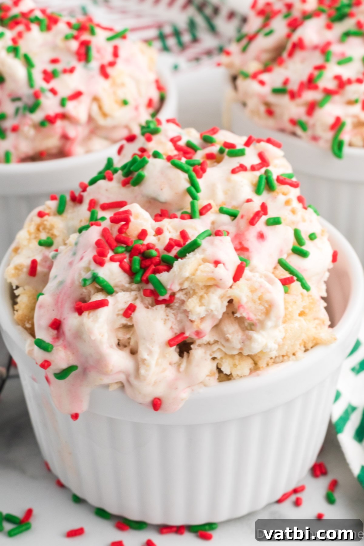 Festive Frozen Delights 2 A beautifully scooped bowl of homemade Christmas Ice Cream, adorned with red and green sprinkles, showcasing its festive appeal.