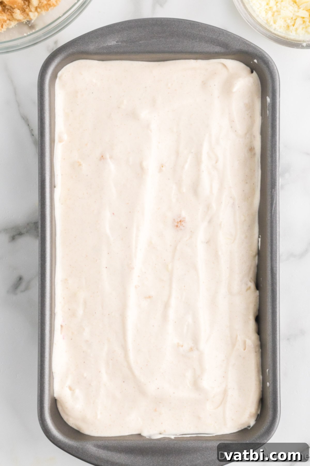 Festive Frozen Delights 11 Multiple layers of ice cream mixture and sprinkles visible within the loaf pan.