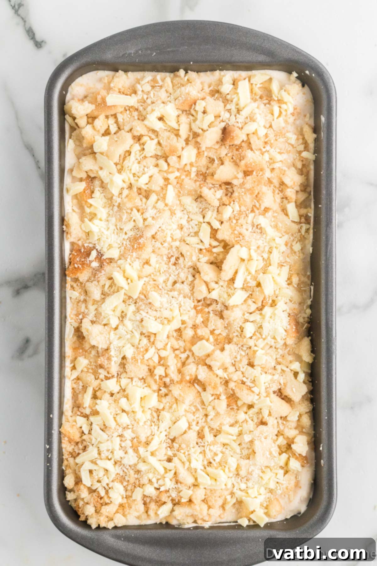 Festive Frozen Delights 12 The top of the ice cream mixture in the loaf pan, sprinkled with remaining crumbled cookies and white chocolate.
