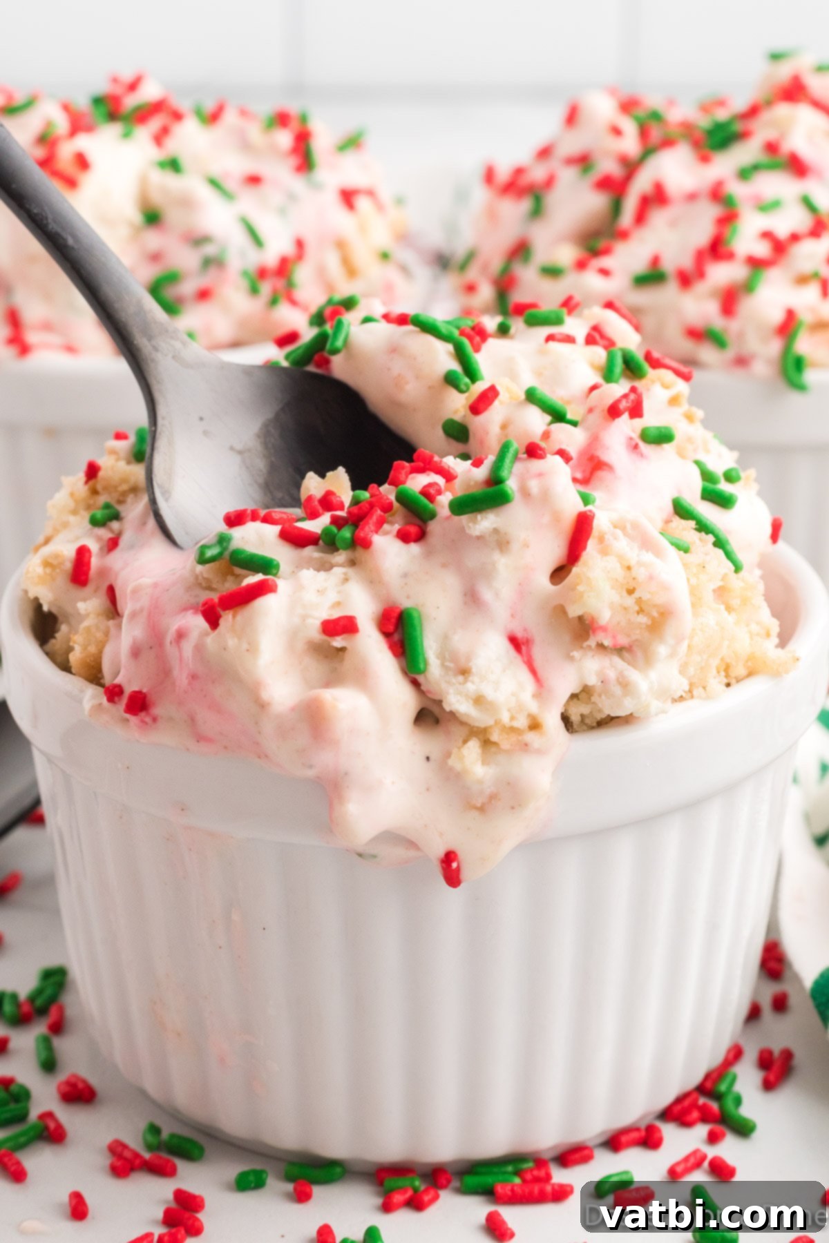 Festive Frozen Delights 14 A bowl of Christmas Ice Cream, garnished with a candy cane, showing its creamy texture and festive sprinkles.