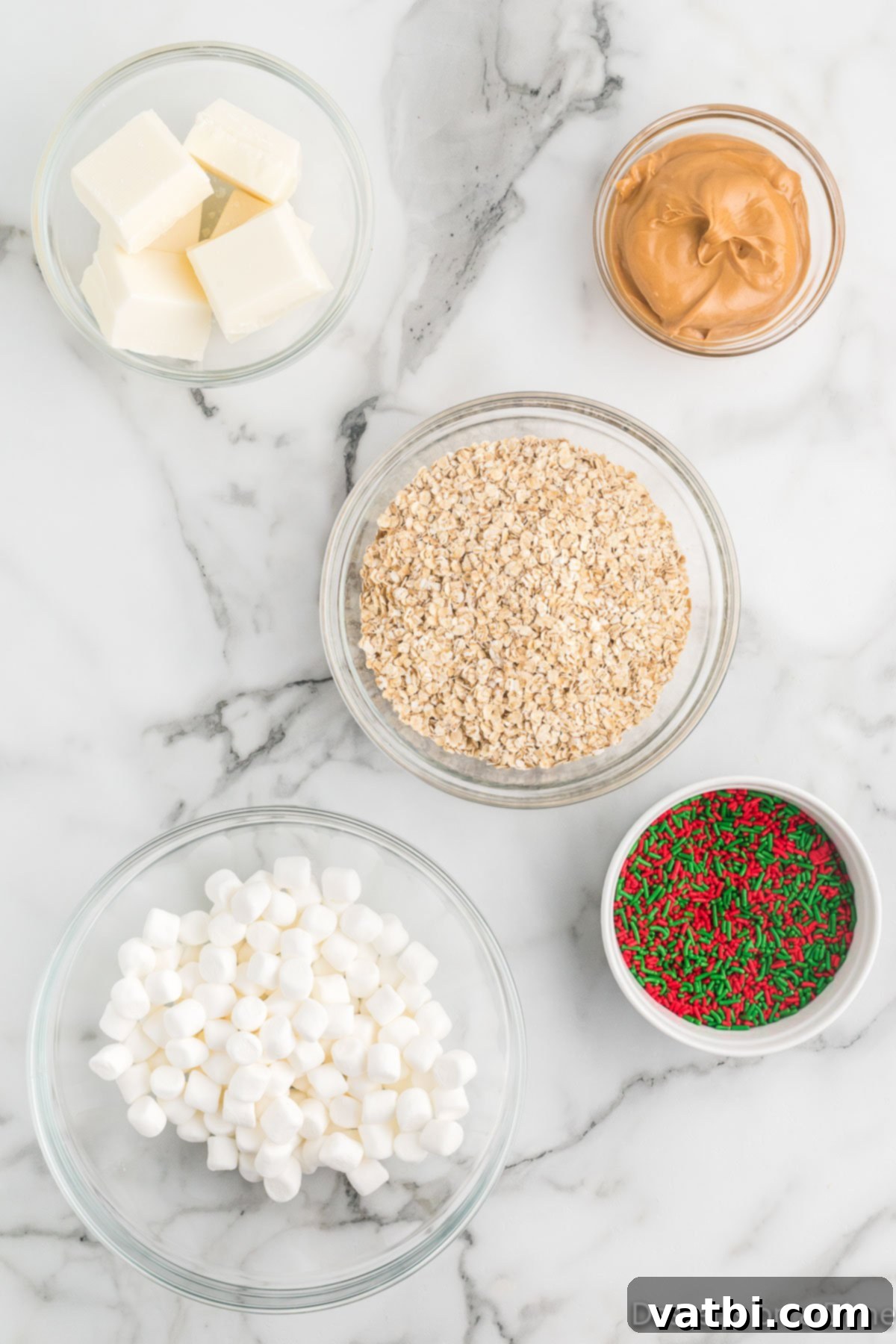 Ingredients for Christmas No Bake Cookies - white chocolate bark, peanut butter, quick oats, mini marshmallows, sprinkles.