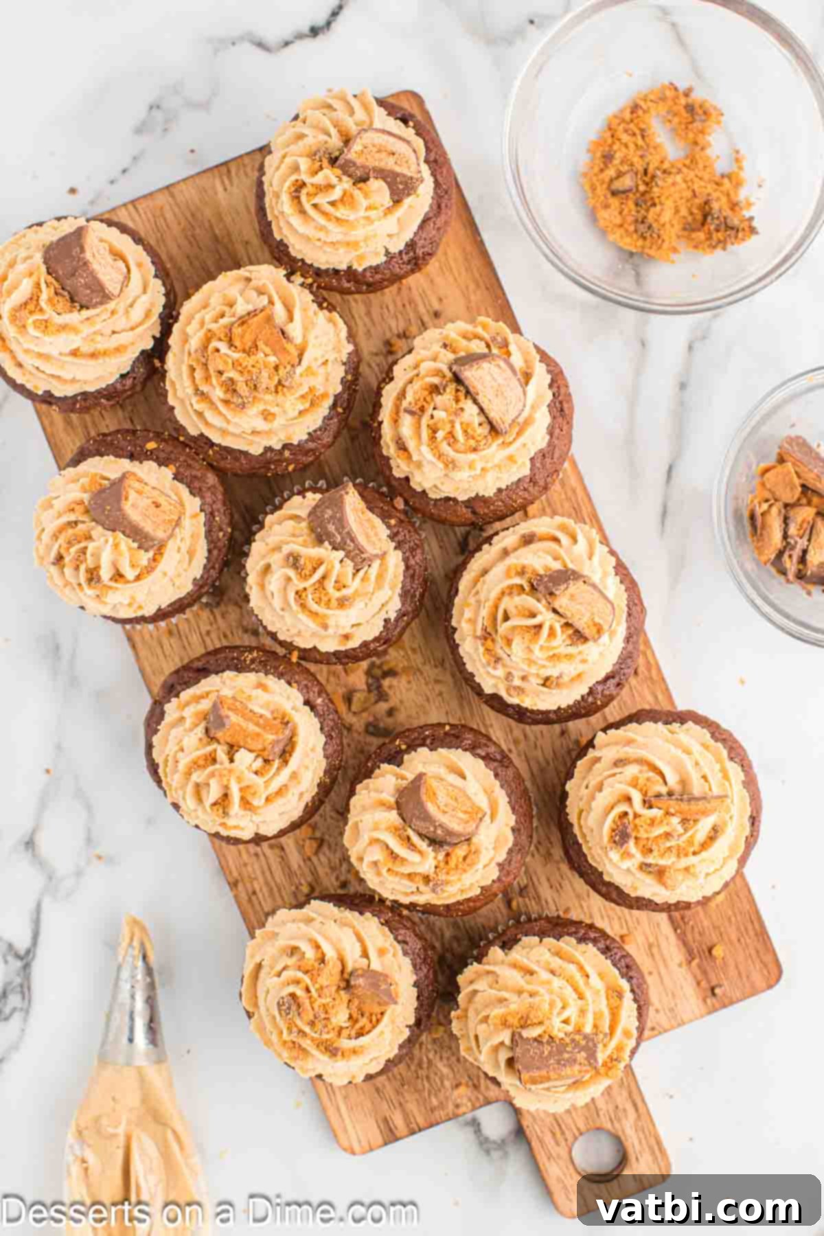 Butterfinger Cupcakes 11 Finished Butterfinger cupcakes topped with peanut butter frosting and crushed candy.