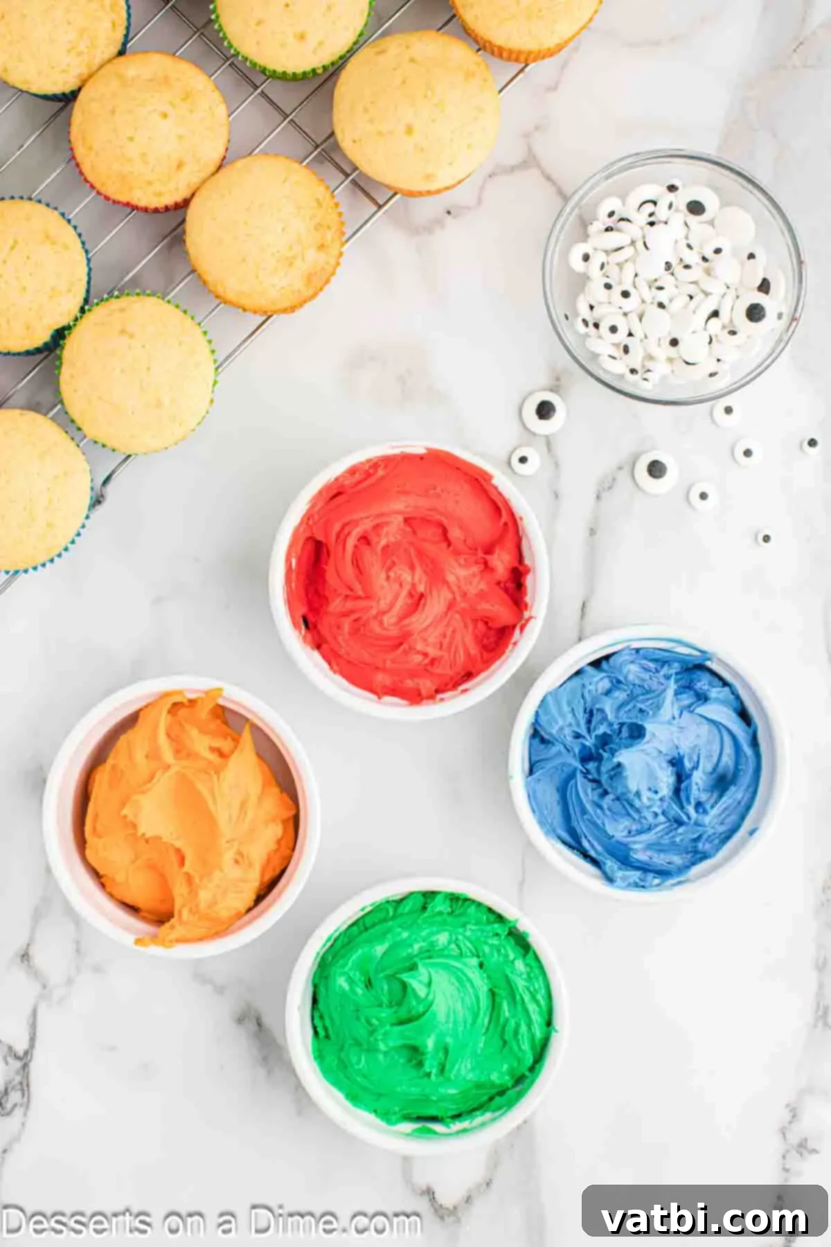 Bowls of frosting in different colors.