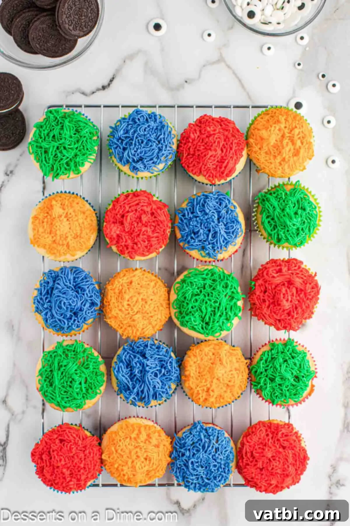 Cupcakes on wire rack decorated with frosting.