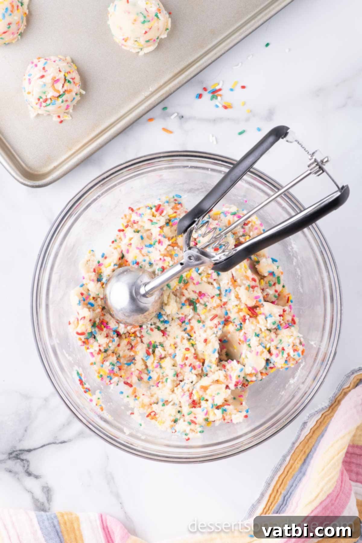 Easy Funfetti Cake Mix Cookies 4 Cookie scoop in dough forming cookies.