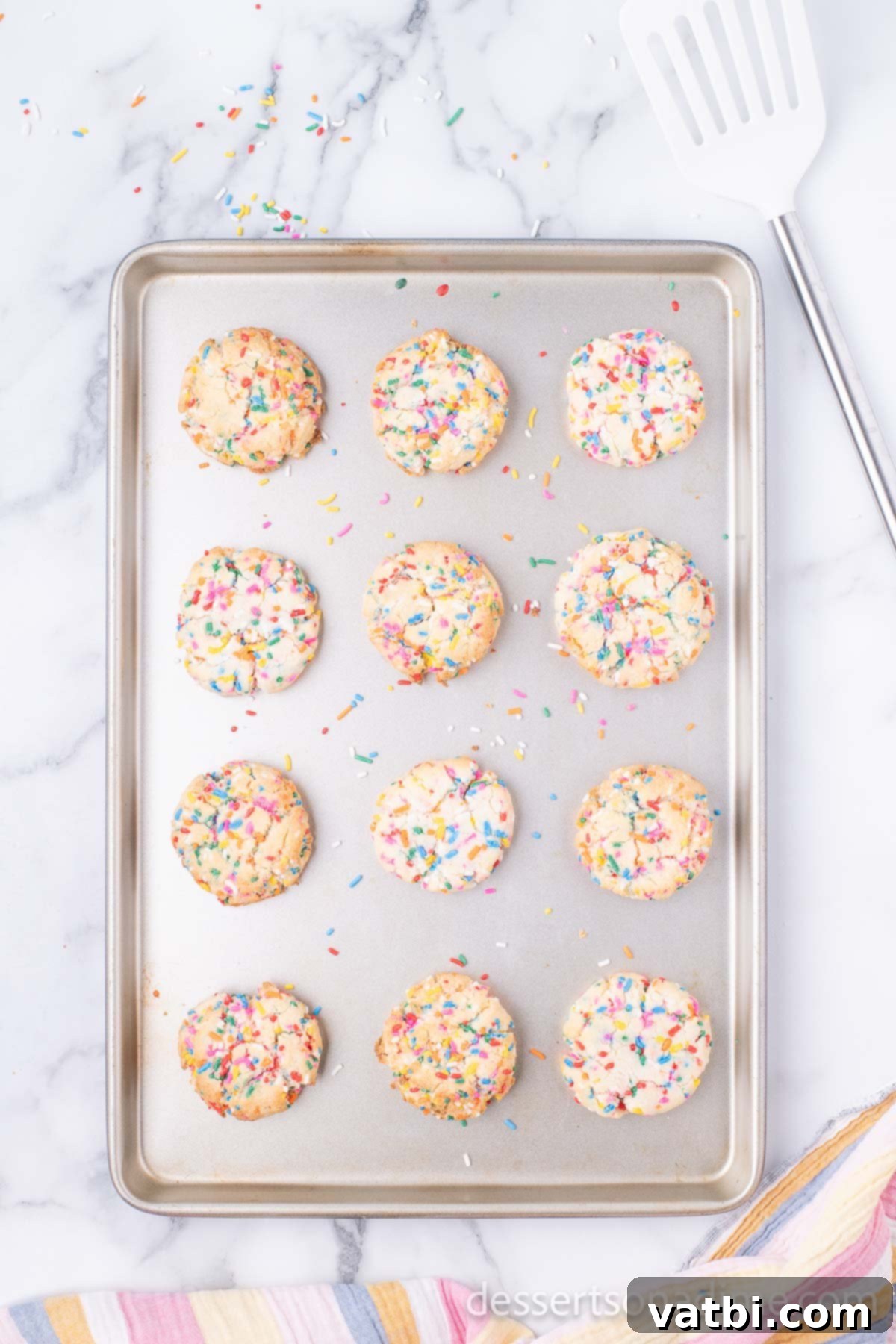 Easy Funfetti Cake Mix Cookies 7 Cookies baked and cooling on baking sheet.