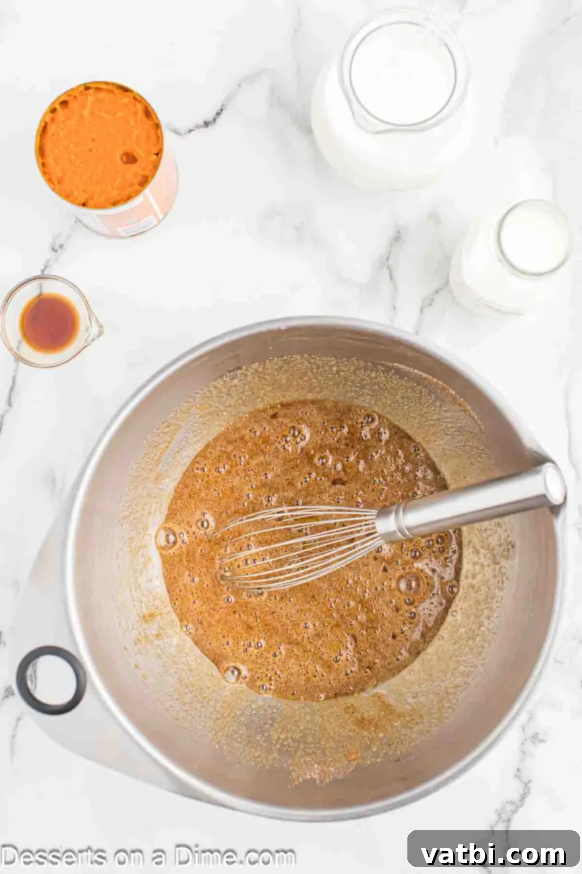 Decadent Pumpkin Bread Pudding 5 Beaten eggs being whisked into the sugar and spice mixture.