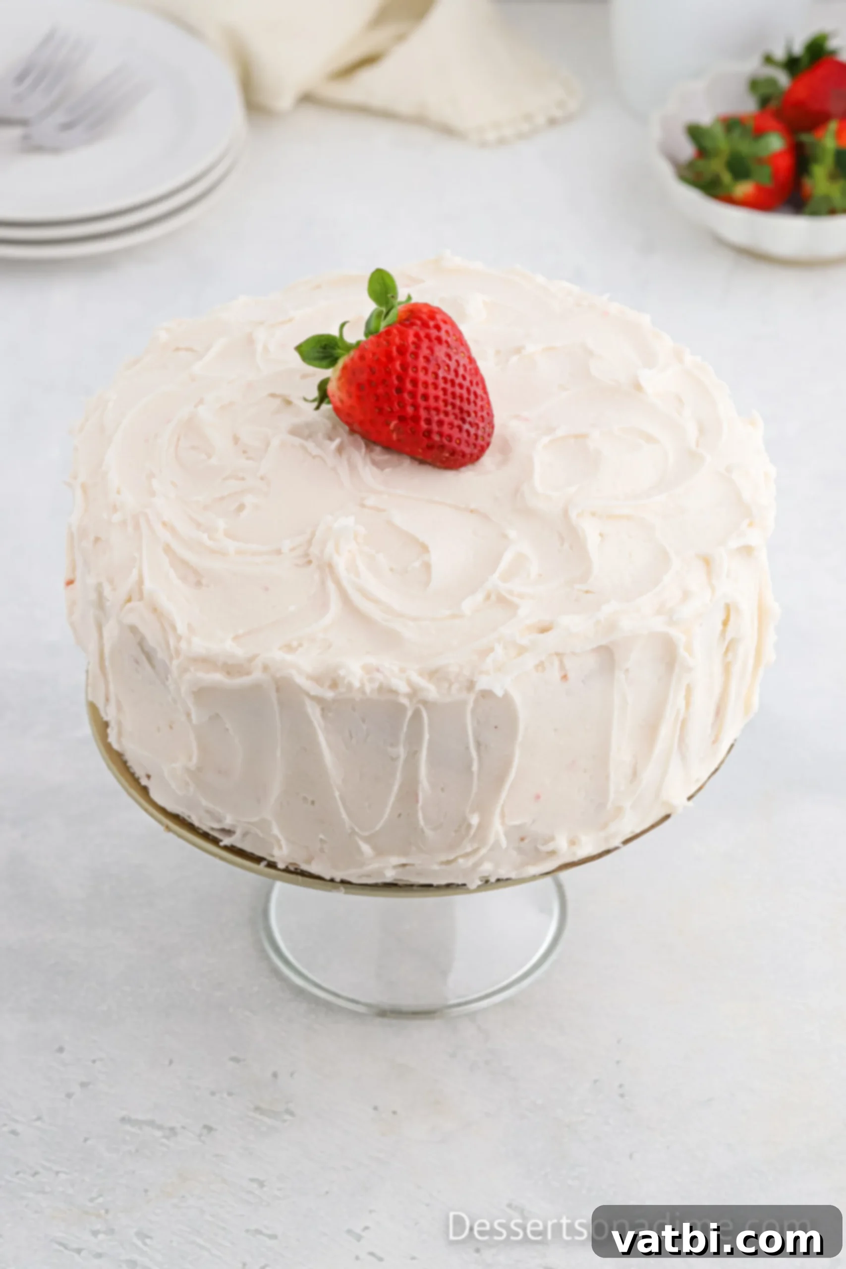 Strawberry cake on cake stand. 