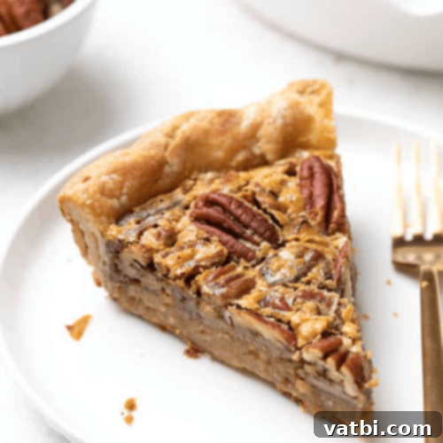 45 Festive Gluten-Free Christmas Delights 28 A slice of Gluten-Free Pecan Pie with a flaky crust, a traditional holiday dessert.