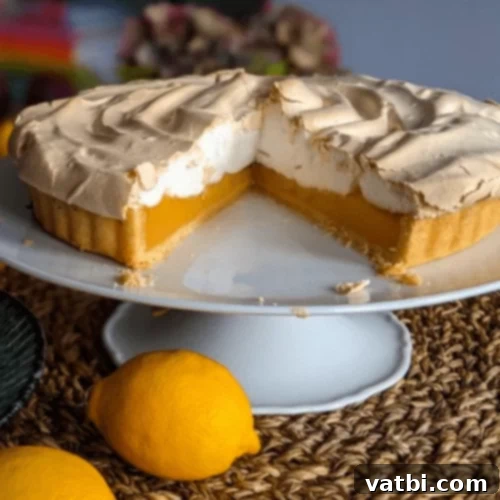 Thanksgiving Dessert Perfection: 35 Gluten-Free Pies 10 A stunning gluten-free Lemon Meringue Pie, with its towering, golden meringue top, presented on a elegant cake stand.