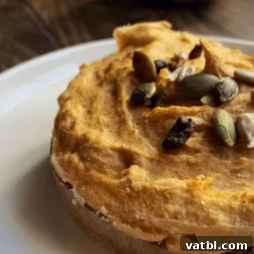 Thanksgiving Dessert Perfection: 35 Gluten-Free Pies 13 A perfectly prepared single-serving hazelnut pumpkin pie, garnished with whole hazelnuts, ready to be enjoyed.