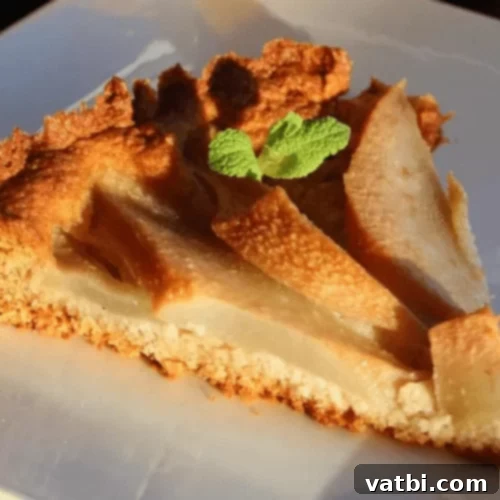 Thanksgiving Dessert Perfection: 35 Gluten-Free Pies 20 An elegant slice of pear and almond tart, showcasing its delicate fruit arrangement and golden crust, served on a plate.