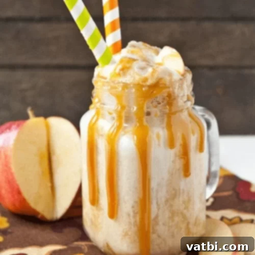 Caramel Apple Cider Floats garnished with apple slices.