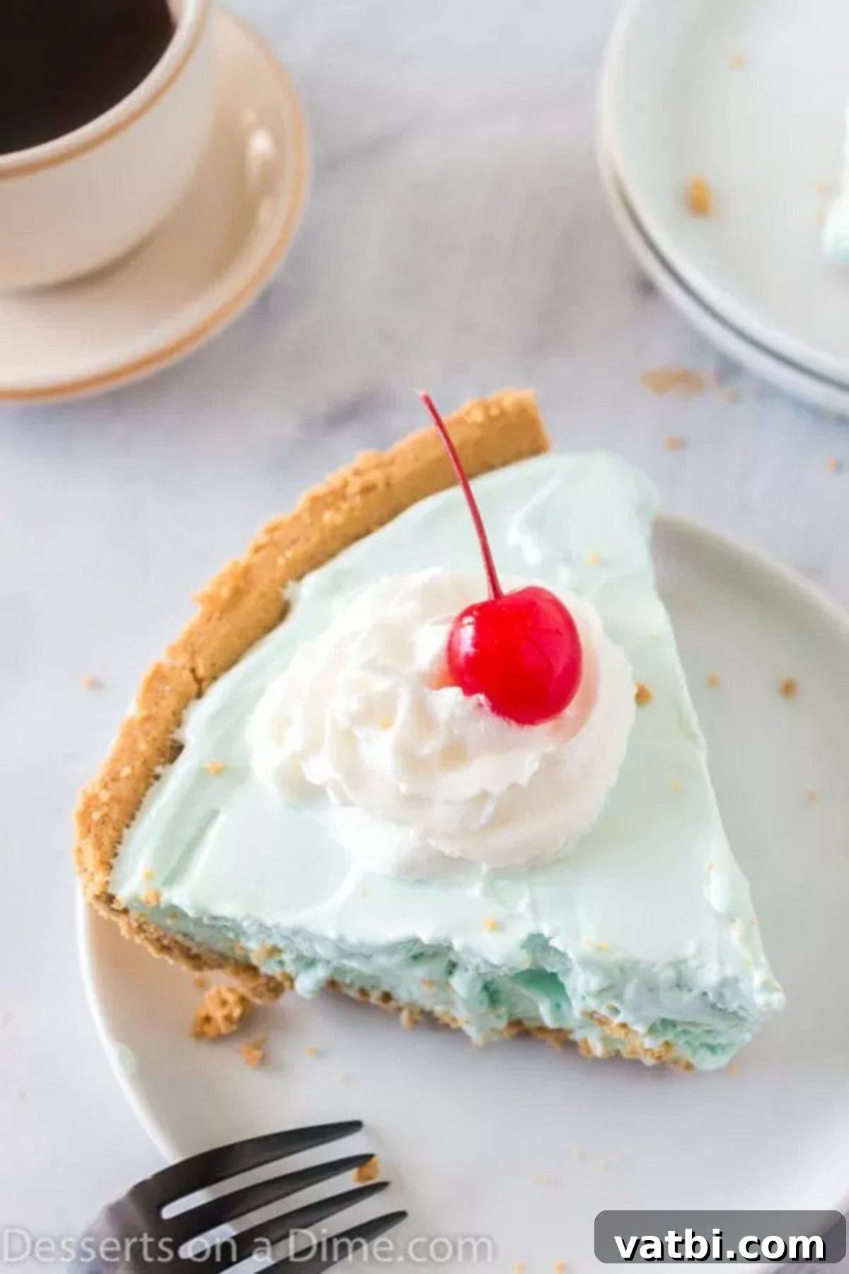Kool Aid Pie Recipe: A Simple, 4-Ingredient, No-Bake Dessert Perfect for Summer or Anytime! A vibrant slice of creamy Kool-Aid pie, with a graham cracker crust, served on a white plate, showcasing its perfect no-bake texture.