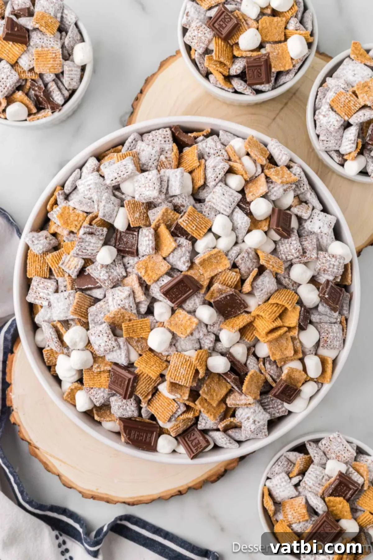 S'mores Campfire Crunch 2 Bowls of S'mores puppy chow ready to enjoy, showcasing the mix of cereal, marshmallows, and chocolate pieces.