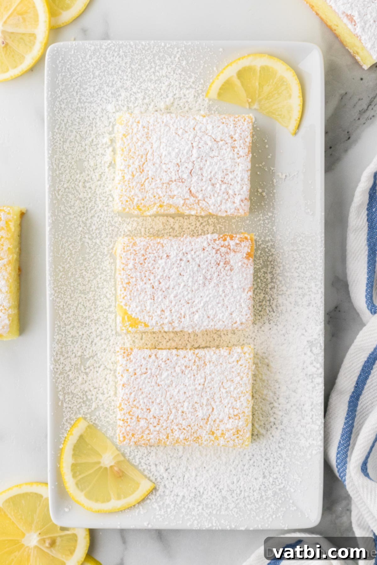 Pile of 2-ingredient lemon bars on a plate, ready to be served or shared.