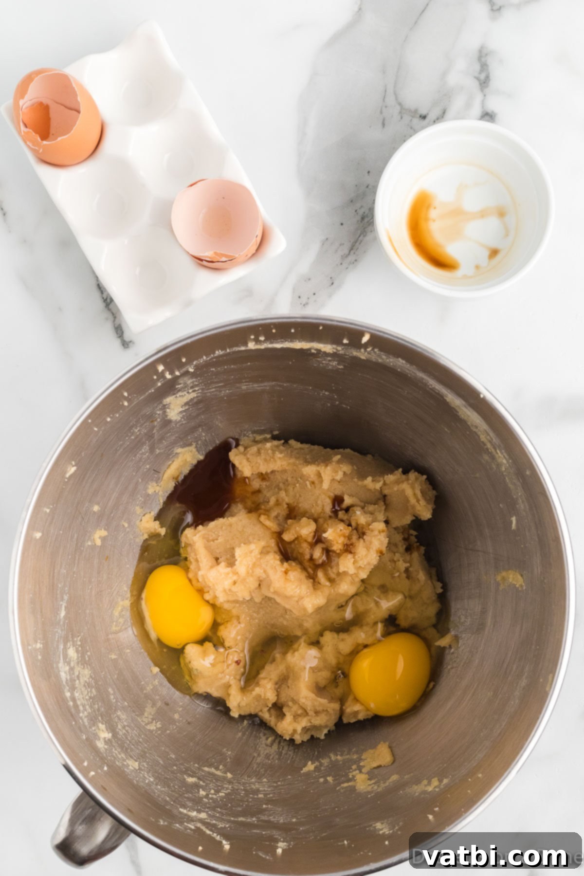 Festive Ranch Cookies 6 Adding two large room temperature eggs one at a time, followed by vanilla extract, to the creamed butter and sugar mixture in a stand mixer.