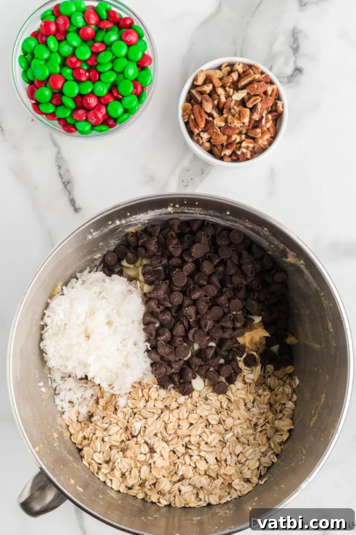 Festive Ranch Cookies 8 Gently stirring in old-fashioned oats, semi-sweet chocolate chips, white chocolate chips, chopped pecans, sweetened flaked coconut, and half of the red and green M&M's into the prepared cookie dough mixture with a spatula.