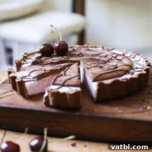 Bake-Free Bliss: 69 Easy Pie Recipes 11 A slice of No Bake Frozen Cherry Chocolate Pie with cherry garnish.
