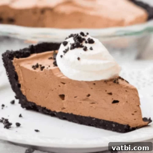 Bake-Free Bliss: 69 Easy Pie Recipes 12 A slice of No Bake Nutella Cheesecake Pie with an Oreo crust and chocolate drizzle.