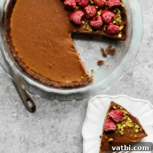Bake-Free Bliss: 69 Easy Pie Recipes 13 A slice of No Bake Chocolate Hazelnut Pie with whipped cream and chopped hazelnuts.