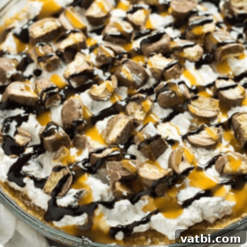 Bake-Free Bliss: 69 Easy Pie Recipes 36 A slice of No Bake Twix Pie with chocolate and caramel drizzle.
