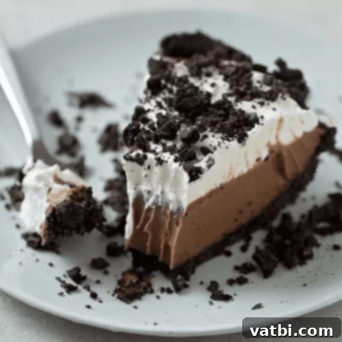 Bake-Free Bliss: 69 Easy Pie Recipes 38 A slice of No Bake Oreo Mud Pie, garnished with crushed Oreos and chocolate drizzle.