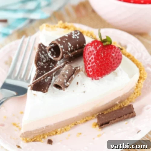 Bake-Free Bliss: 69 Easy Pie Recipes 52 A slice of No Bake Neapolitan Cheesecake Pie with fresh strawberries.