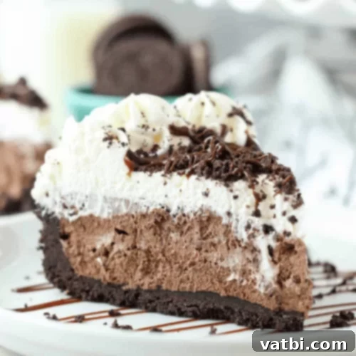 Bake-Free Bliss: 69 Easy Pie Recipes 66 A slice of No Bake Chocolate Marshmallow Pie with whipped cream, marshmallows, and chocolate shavings.