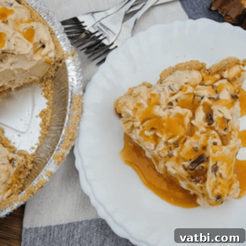 Bake-Free Bliss: 69 Easy Pie Recipes 67 A slice of No Bake Butterscotch Apple Pie With Snickers, showing chunks of candy.