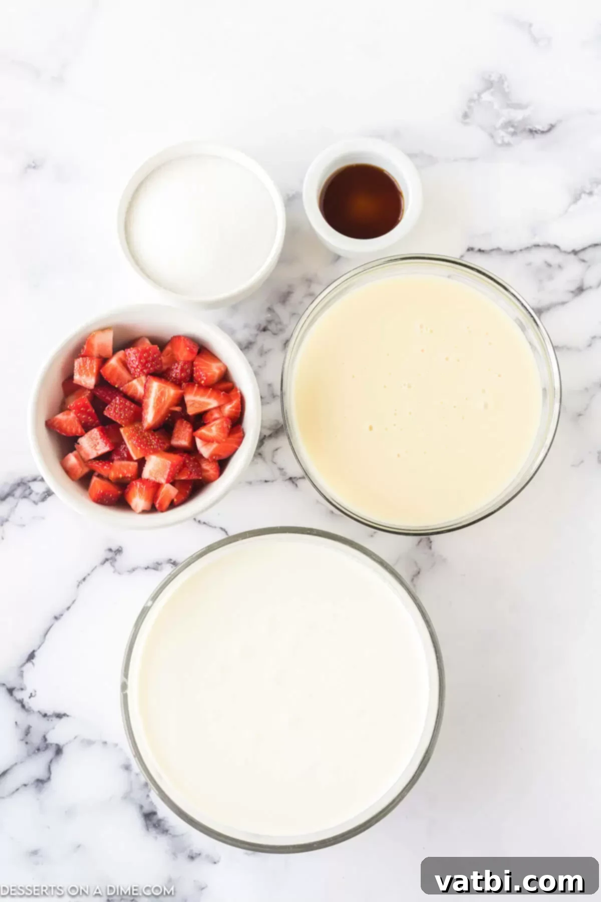 Easy No-Churn Strawberry Ice Cream 3 A collection of the five simple ingredients needed for no-churn strawberry ice cream: heavy whipping cream, vanilla extract, sweetened condensed milk, fresh diced strawberries, and white granulated sugar.