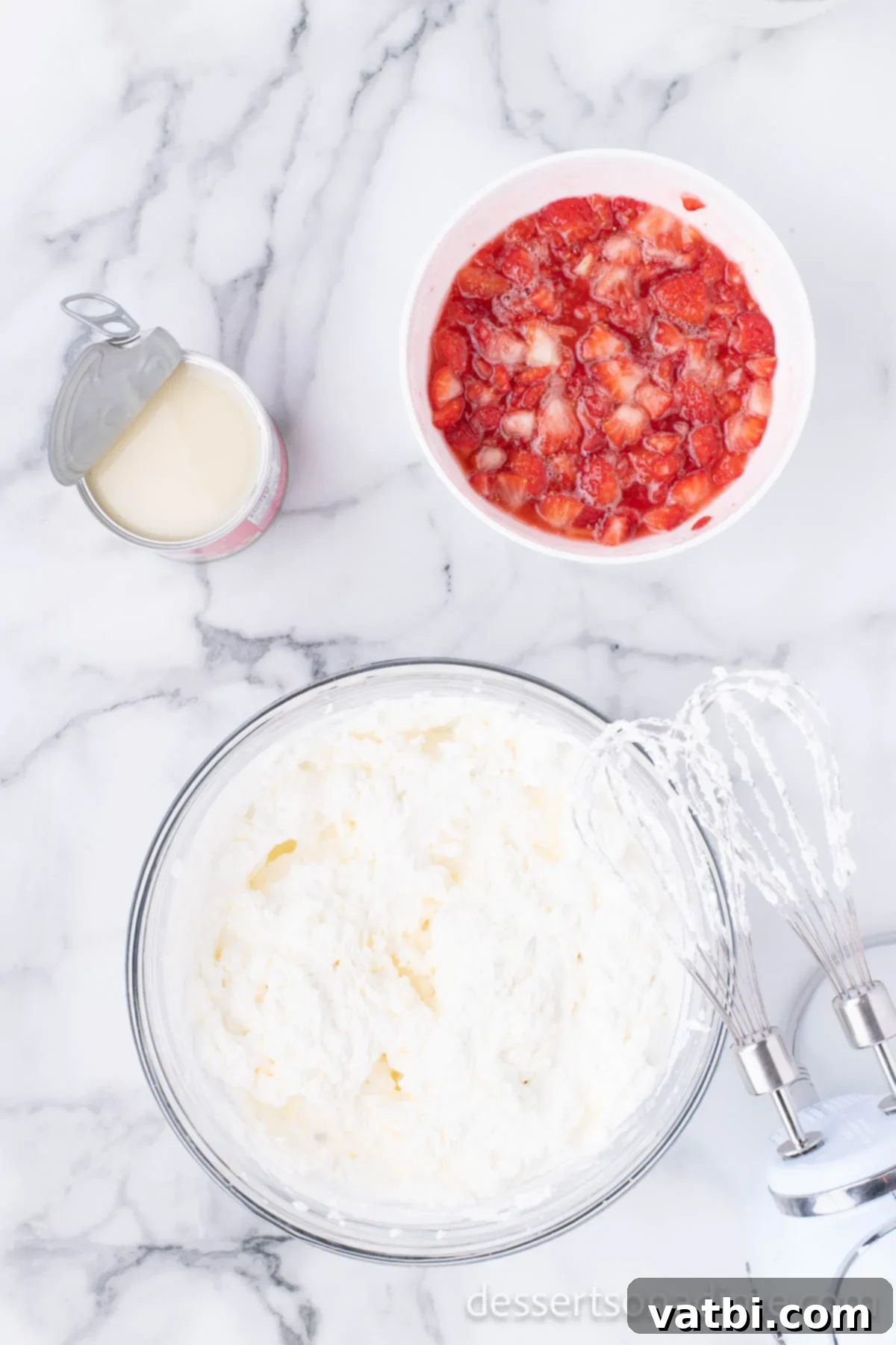 Easy No-Churn Strawberry Ice Cream 5 A mixing bowl with cold heavy whipping cream and vanilla extract, ready to be whipped to stiff peaks.