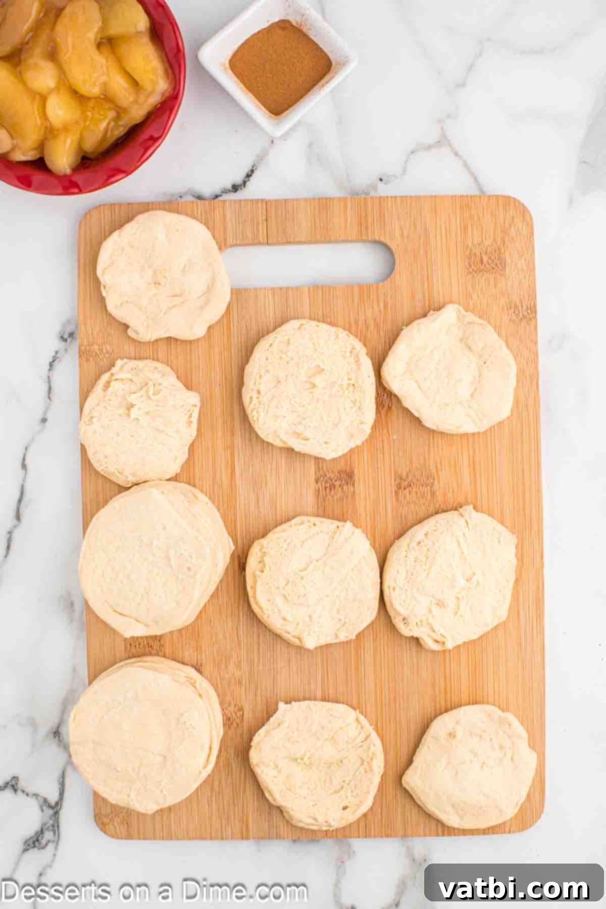 Air-Fried Apple Pie Puffs 4 Biscuits on a cutting board being separated into individual layers.