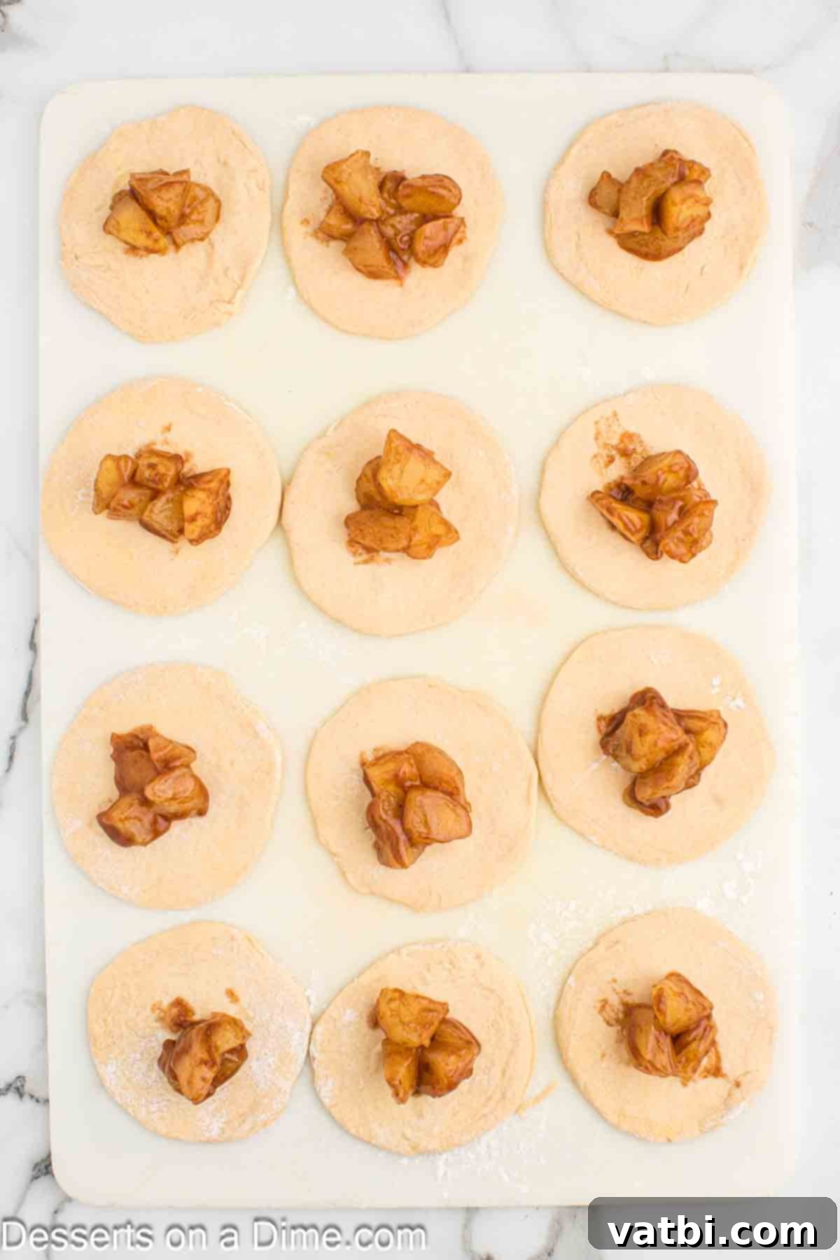 Air-Fried Apple Pie Puffs 7 A spoonful of apple pie filling placed in the center of a rolled biscuit circle.