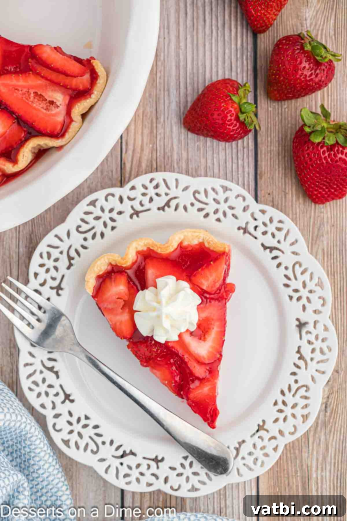 Perfect Strawberry Pie 9 Slice of pie on plate topped with whipped cream.