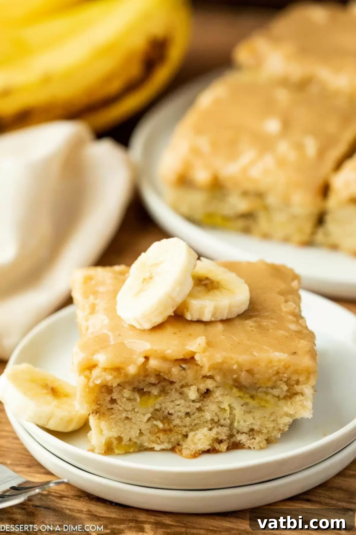 Fudgy Banana Bread Brownies 2 Freshly baked Banana Bread Brownies with brown butter frosting, cut into perfect squares and ready to serve.