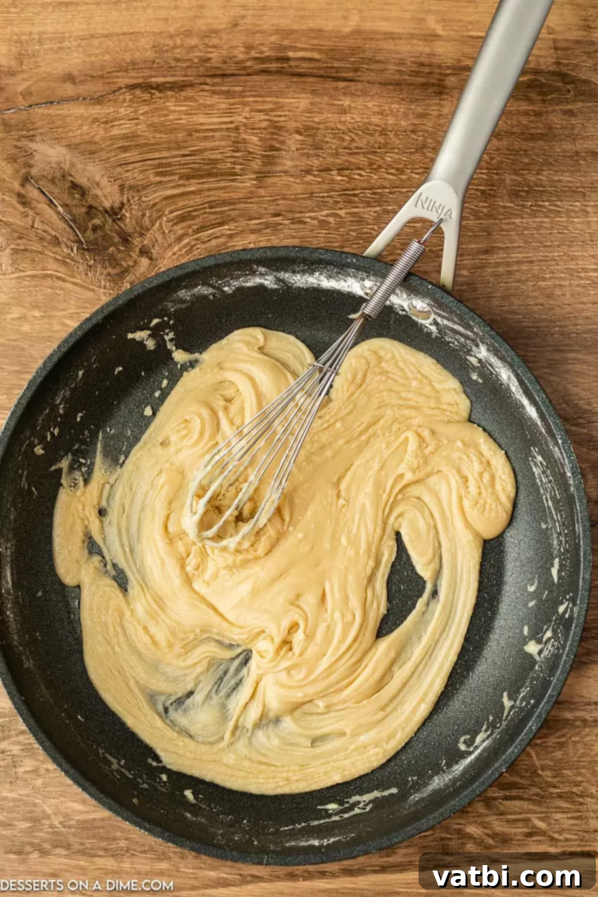 Fudgy Banana Bread Brownies 10 Brown sugar being whisked into the browned butter in a skillet, creating a base for the frosting.