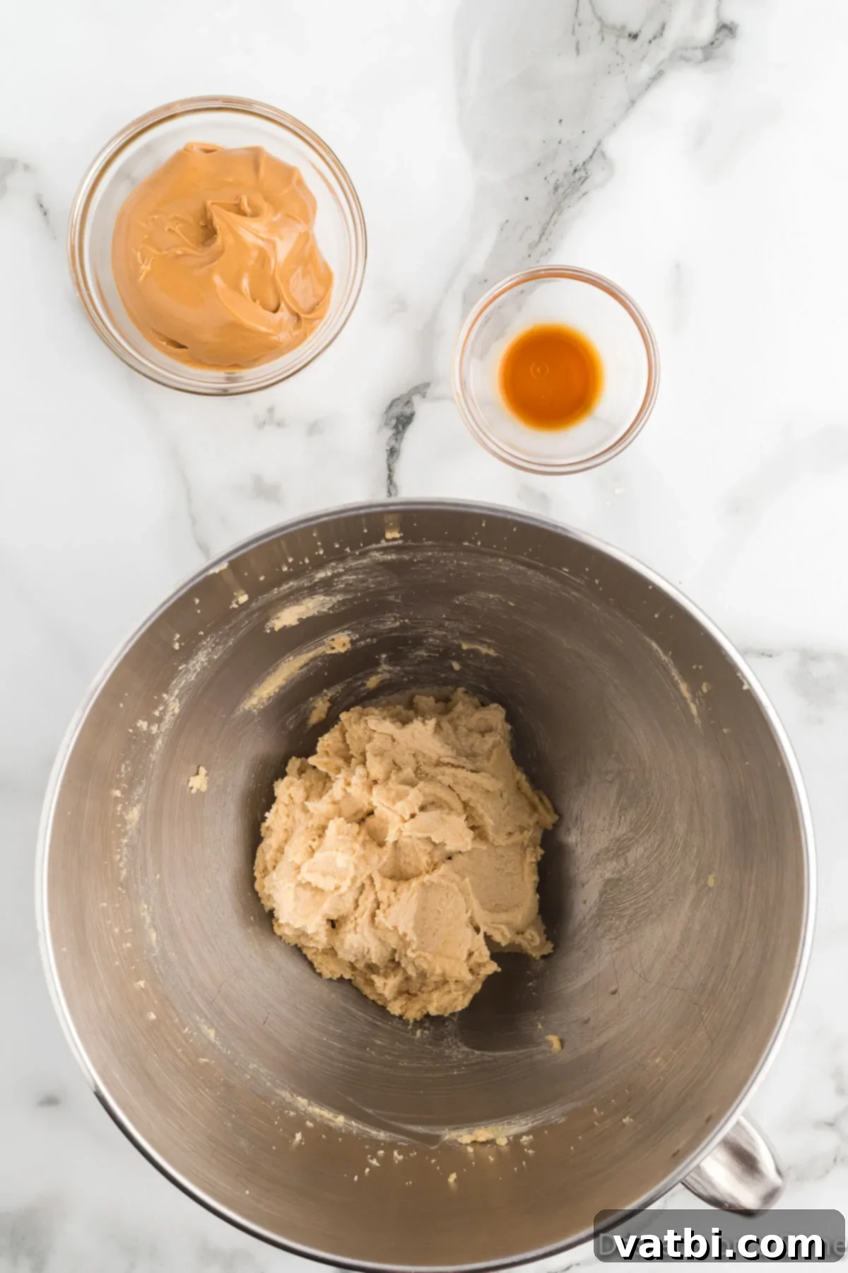 Reese's Pieces Peanut Butter Perfection 6 Creamy peanut butter being mixed into the creamed butter and sugar mixture.