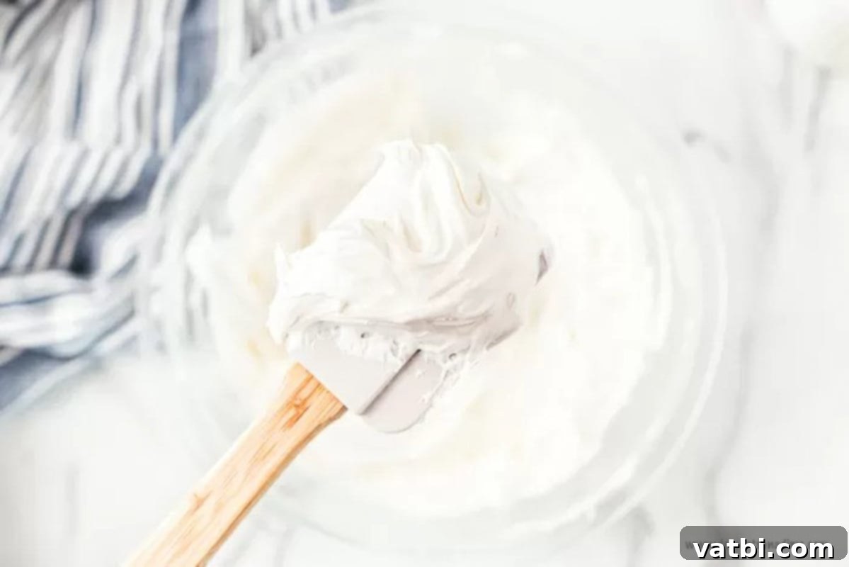Decadent No-Bake Oreo Lasagna 4 Mixing bowl with a creamy cream cheese mixture
