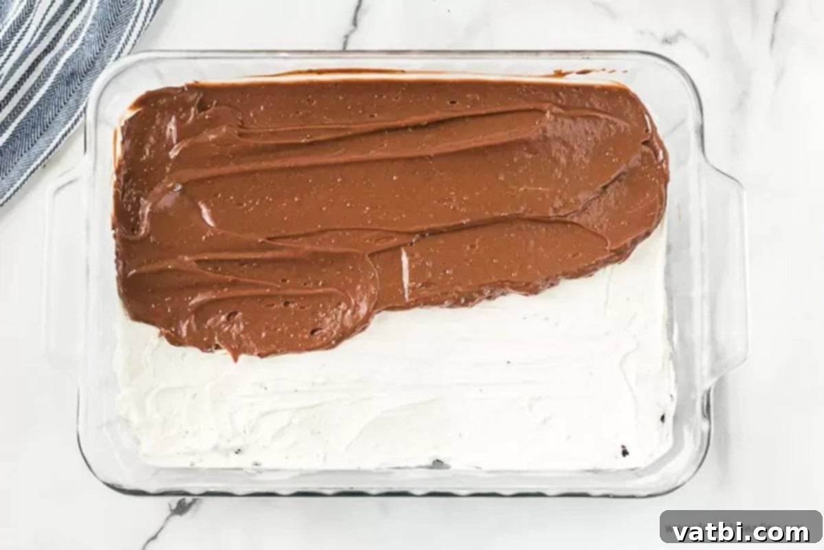 Decadent No-Bake Oreo Lasagna 6 Chocolate pudding layer spread on top of the cream cheese filling