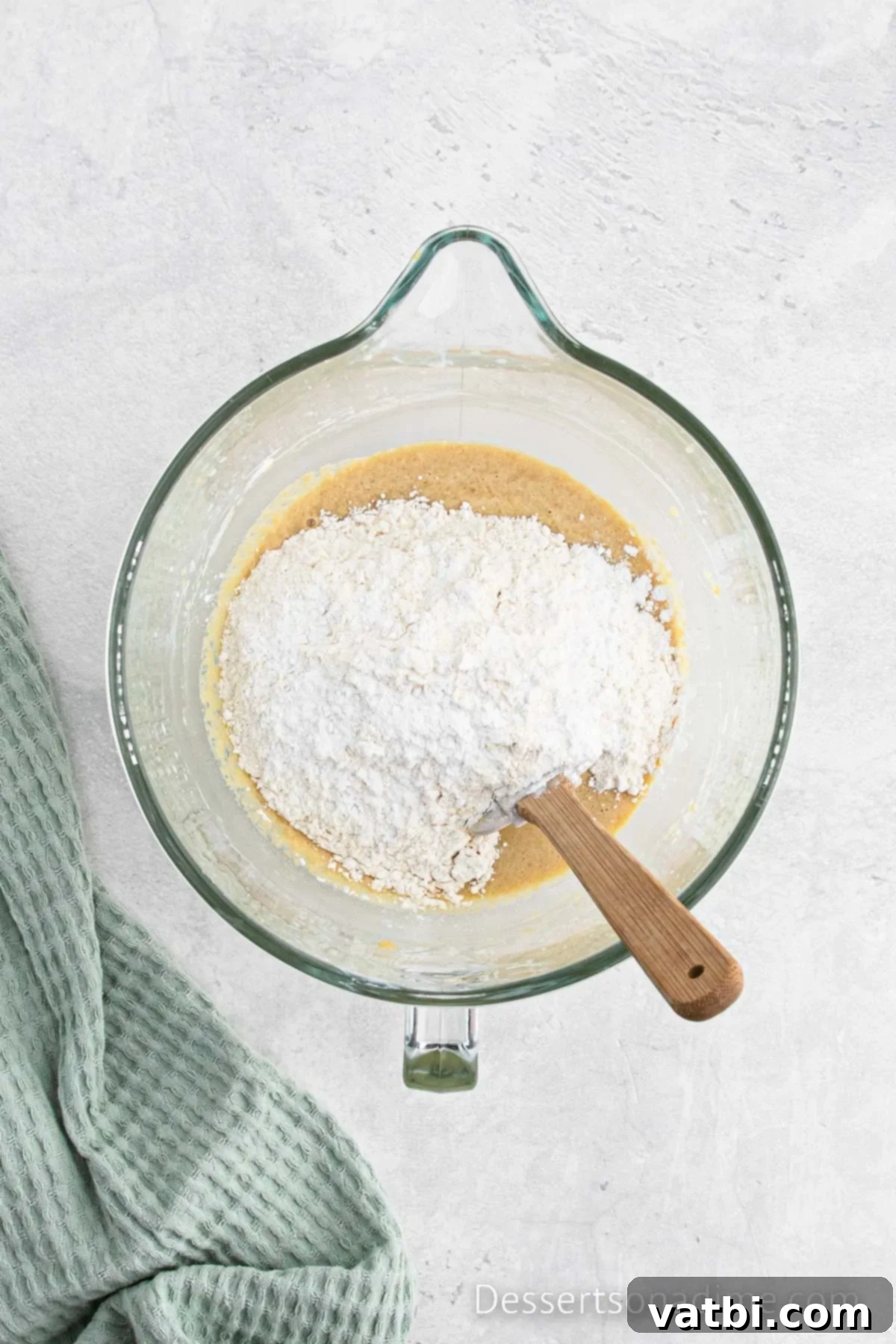 Cinnamon Sugar Snickerdoodle Bread 6 Mixer bowl showing dry ingredients (flour, baking powder, salt) being folded into the wet ingredients.