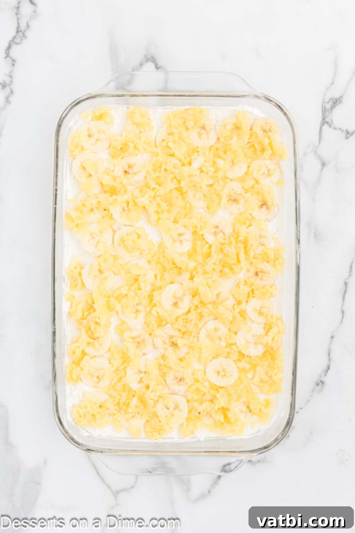 Pineapple sprinkled on top of pan. 
