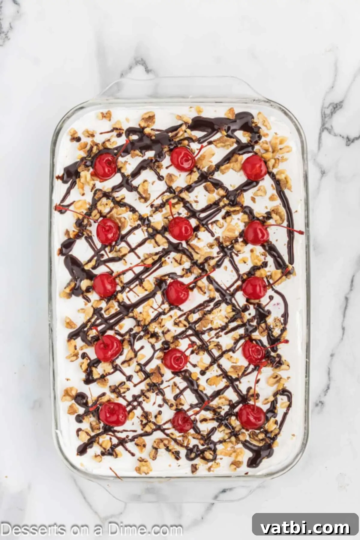 Chocolate drizzled on top with cherries. 