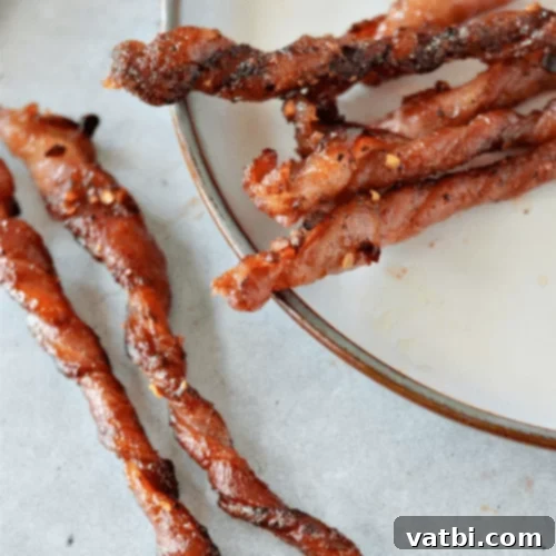Crispy Low-Carb Candied Bacon Twists on a baking sheet.
