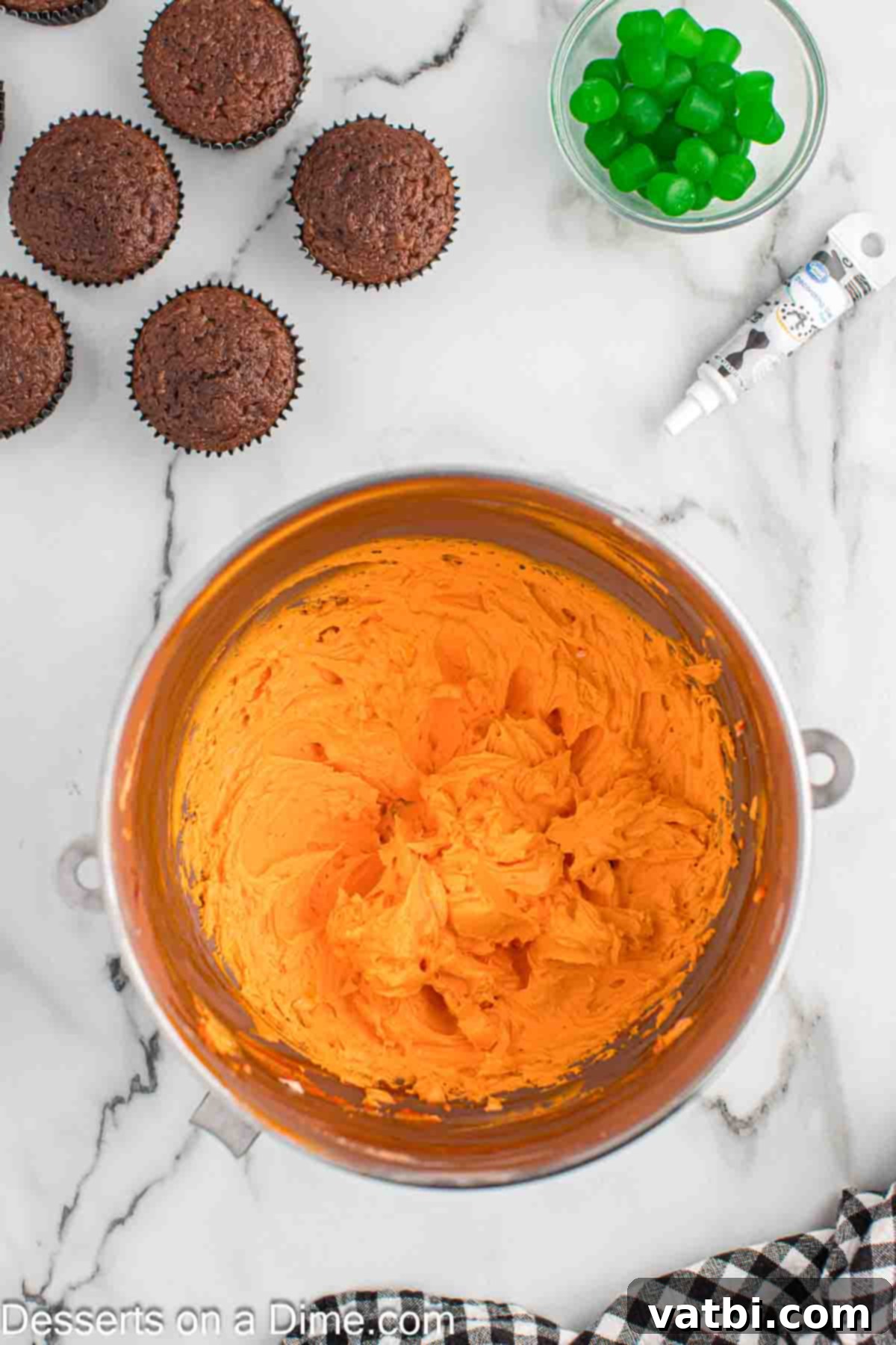 Carved Pumpkin Cupcakes 7 Vibrant orange frosting in a mixing bowl after adding orange gel food coloring.