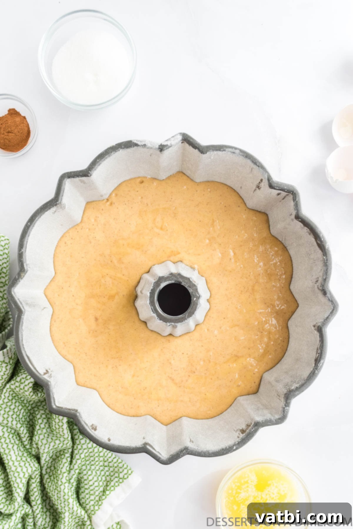 Harvest Apple Cider Bundt 7 Cake batter settled in a bundt pan, showing its smooth surface before baking.