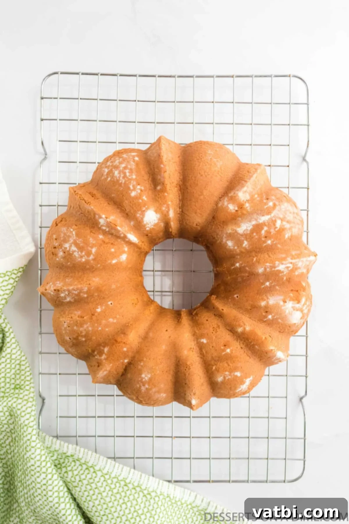 Harvest Apple Cider Bundt 9 A beautiful, golden brown Apple Cider Bundt Cake cooling upside down on a wire rack after being removed from the pan.