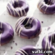 Irresistible Donut Ideas 27 Ube donuts with a vibrant purple glaze.